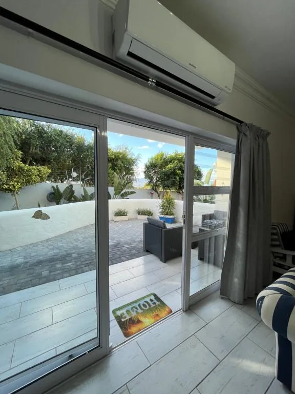 Modern patio with sliding glass doors opening onto outdoor seating area
