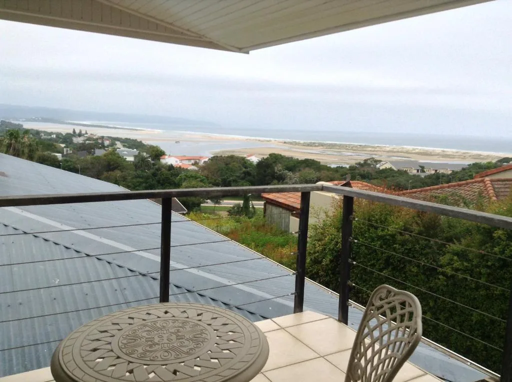 Panoramic lagoon and coastline view from elevated deck with seating