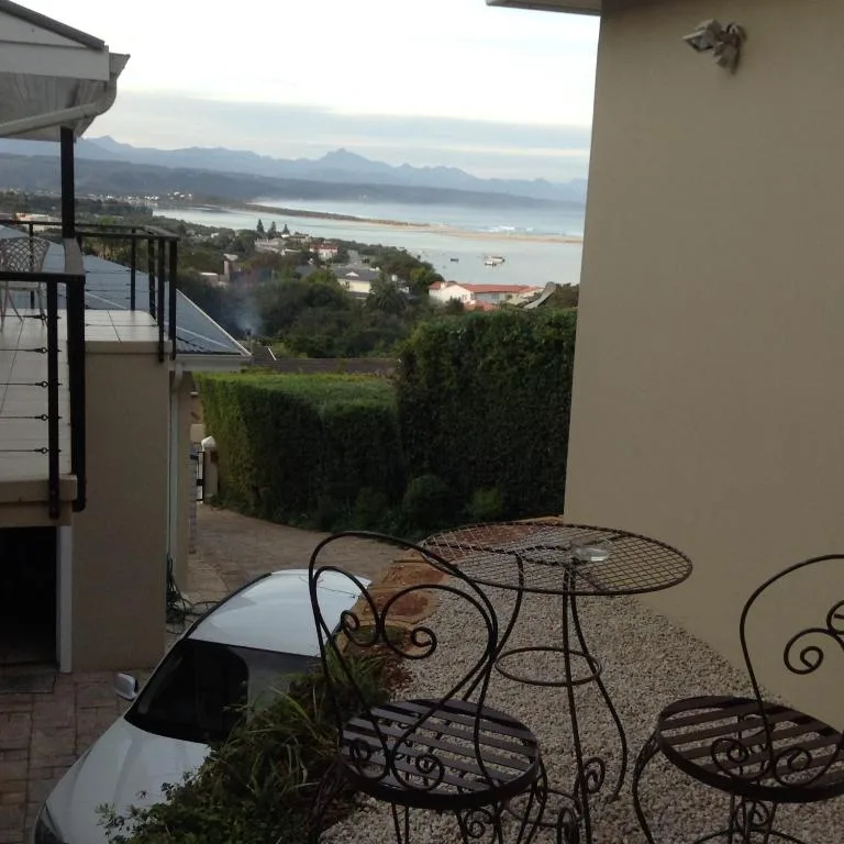 Coastal panorama of Plettenberg Bay lagoon and mountains from deck