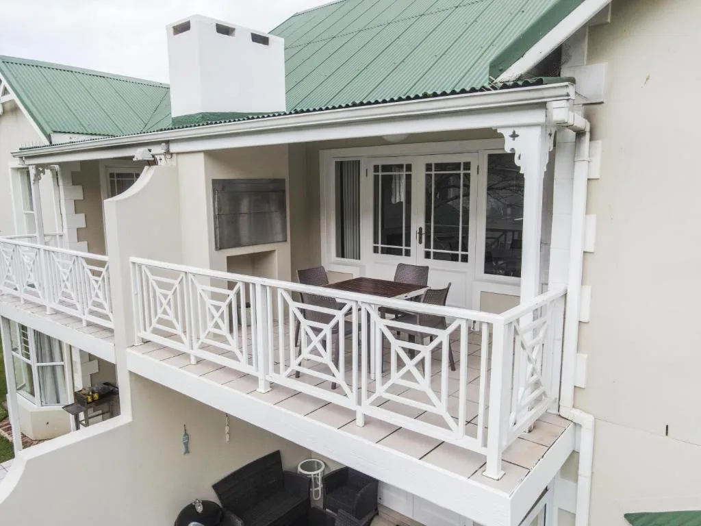 Spacious upper deck with white railings and outdoor seating area