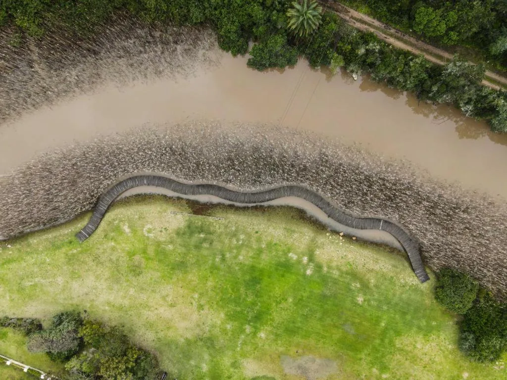 Aerial view of lush green grounds with winding river and vegetation