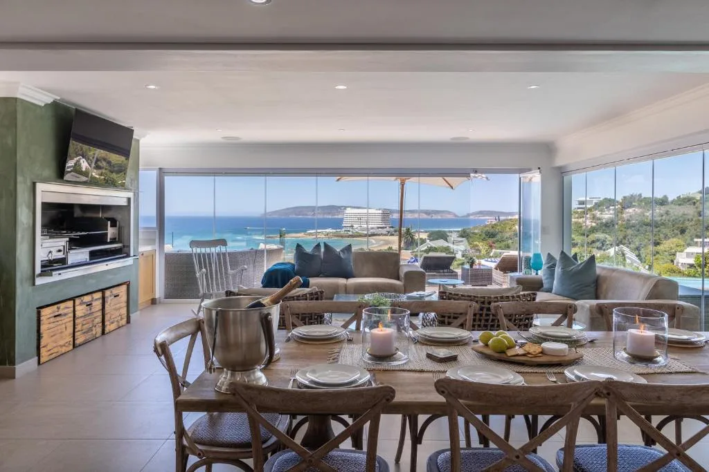 Coastal ocean view with mountains and resort visible from dining room