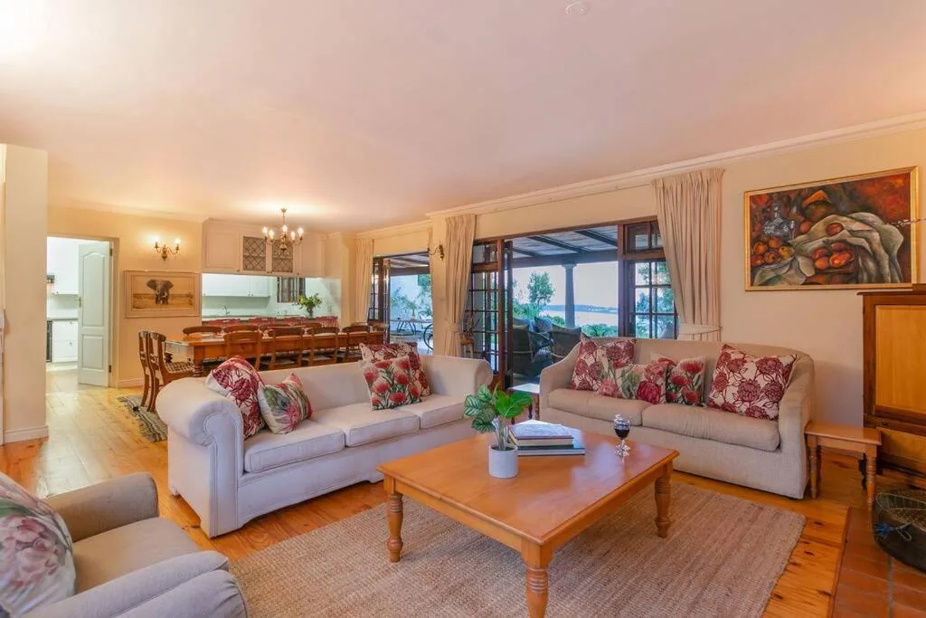 Spacious lounge with elegant sofas, wooden coffee table, and ocean views