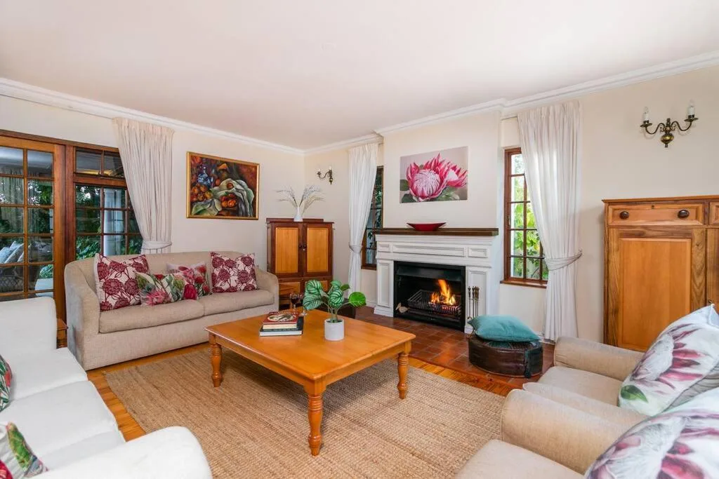 Elegant living room with fireplace, cream sofas, wooden coffee table