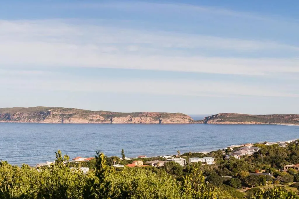 Scenic coastal view of Plettenberg Bay with rocky headlands and blue waters