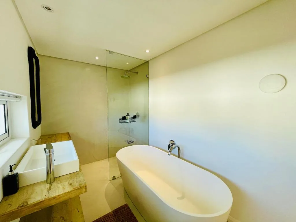 Modern bathroom with freestanding bathtub and glass shower enclosure
