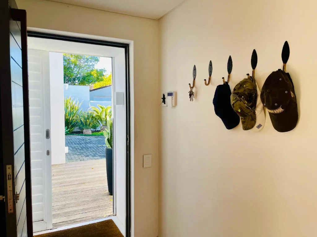 Decorative hat hooks and garden access through open glass doors