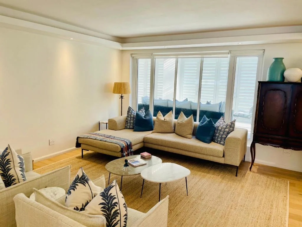 Spacious lounge with cream sectional sofa, mountain views through large windows