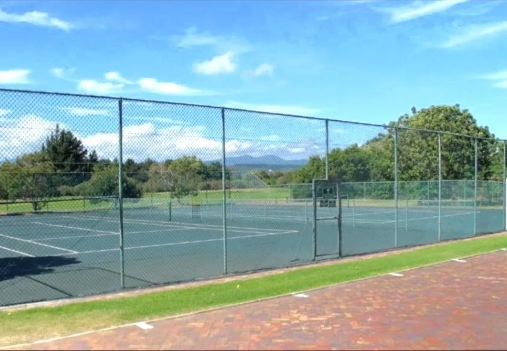 Tennis courts with mountain views in a green garden estate setting