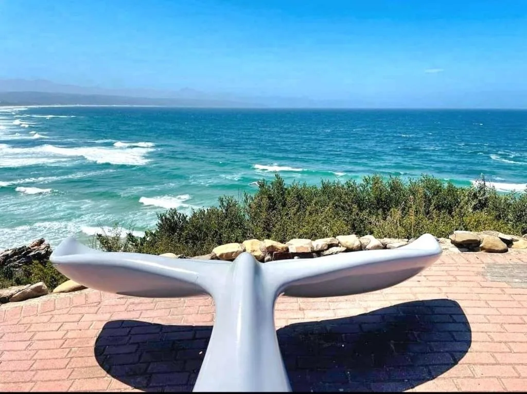 Turquoise ocean waves and coastal landscape seen from property deck