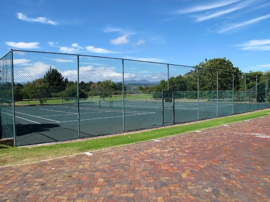 Tennis courts with brick paving and mountain views in distance
