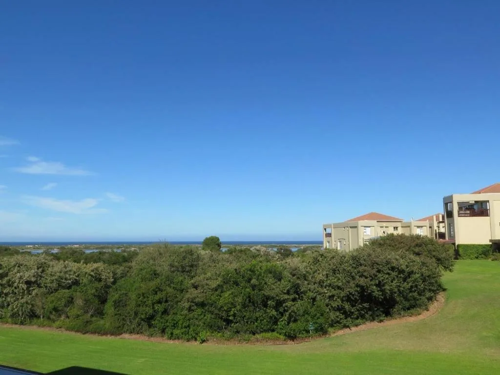 Ocean and lagoon vista from elevated garden with coastal vegetation