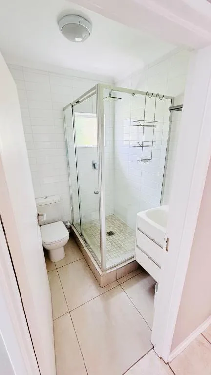 Modern bathroom with glass shower enclosure and white vanity sink