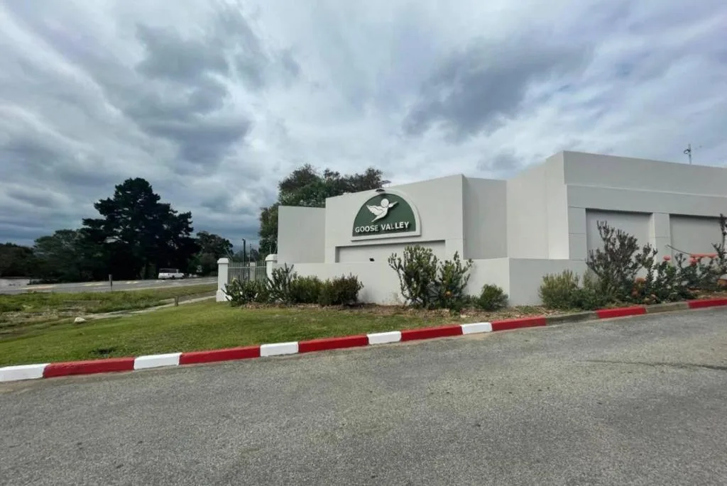 Modern white building with Goose Valley signage and manicured grounds