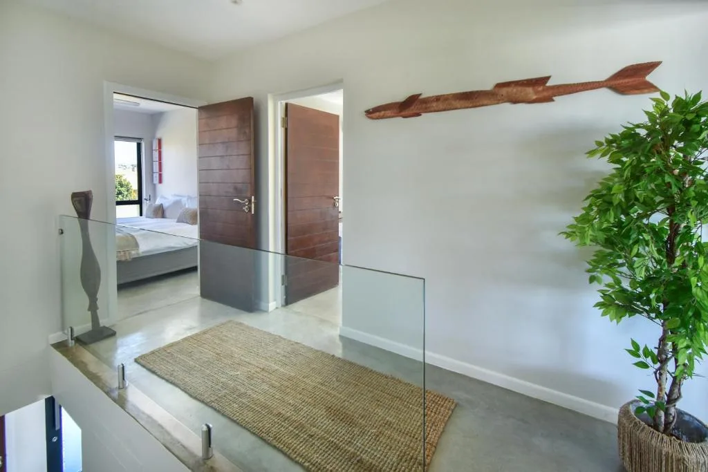 Modern lounge with wooden doors, sculptural decor, and potted plant