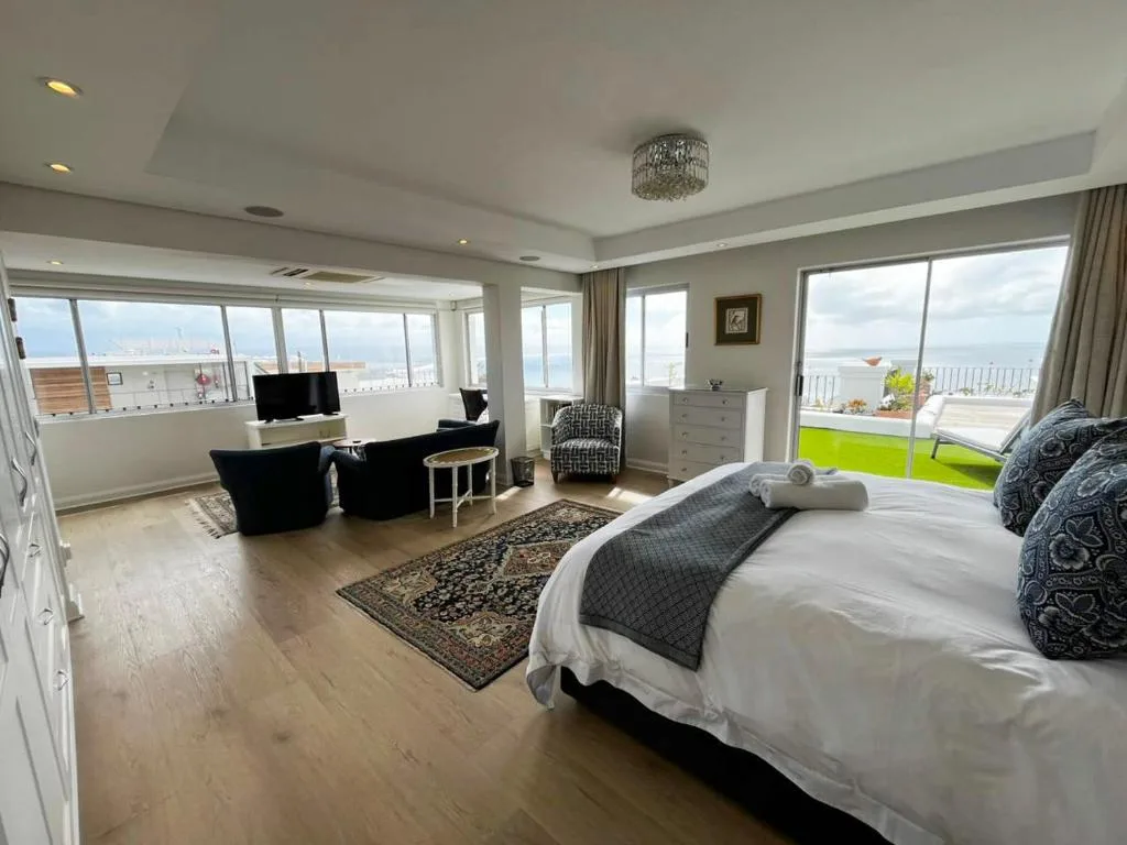 Spacious penthouse bedroom with ocean views and modern furnishings