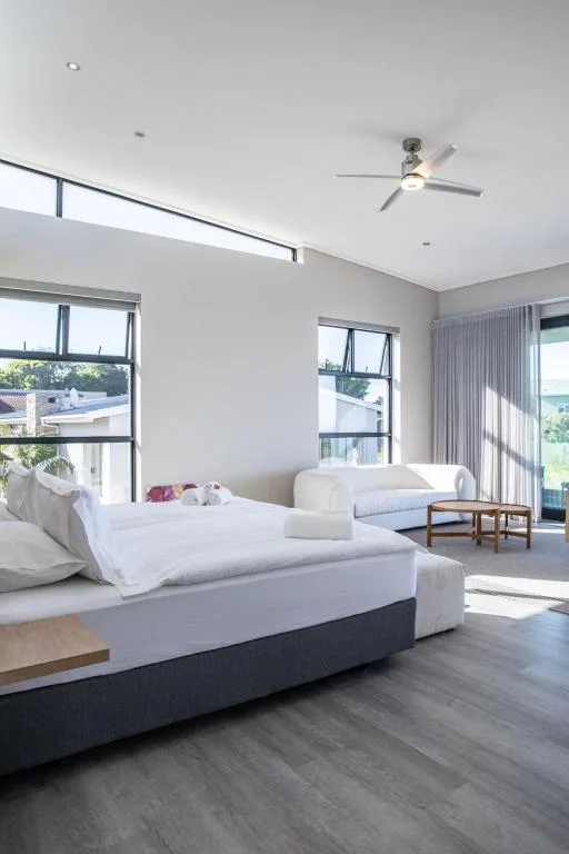 Spacious modern bedroom with twin beds and ocean view windows