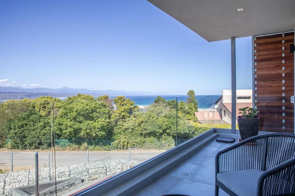 Modern deck with ocean and mountain views overlooking Plettenberg Bay
