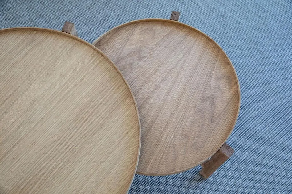 Wooden serving platters with handles on blue textile background