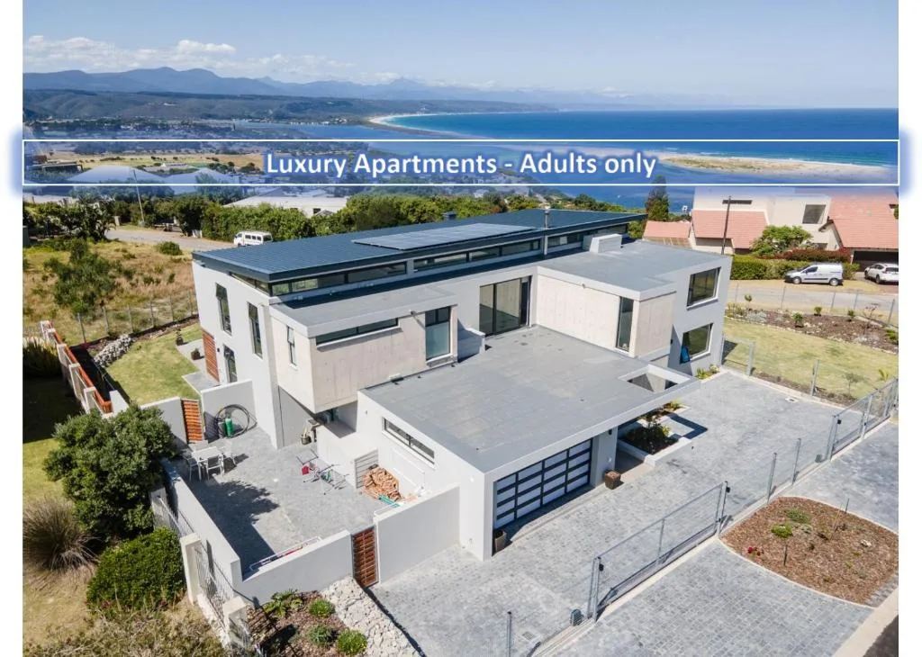 Modern white and blue luxury apartment building with ocean and mountain views