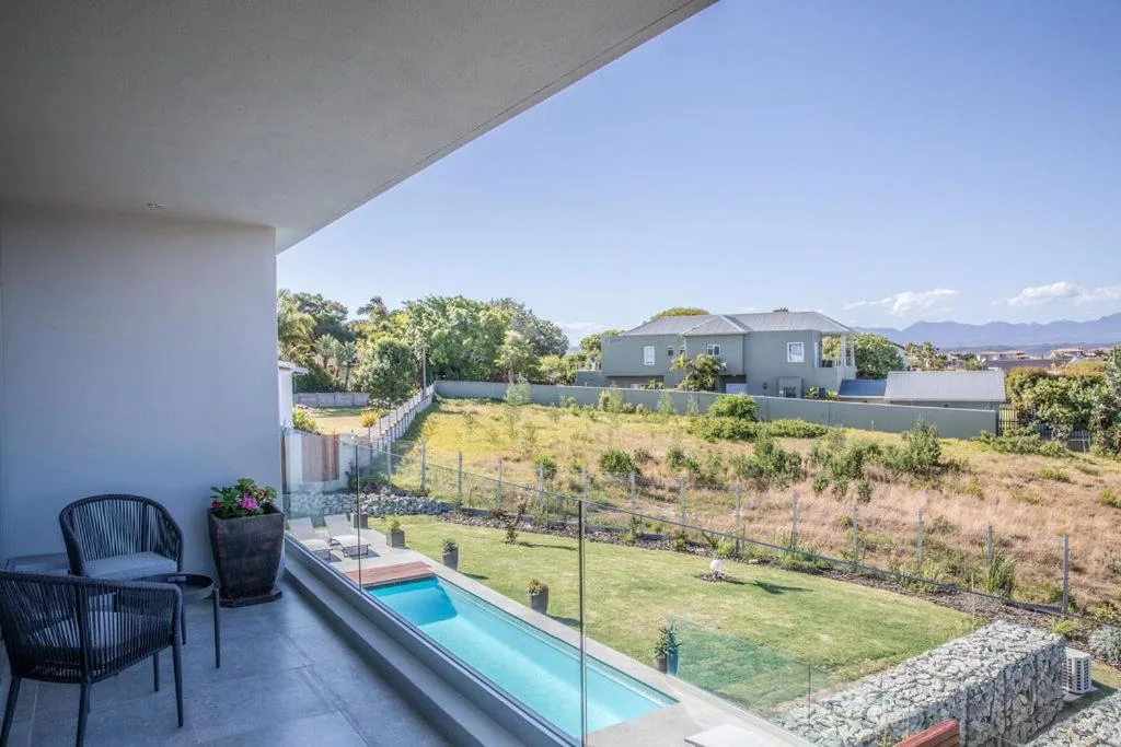 Rectangular lap pool with mountain views and seating area on deck