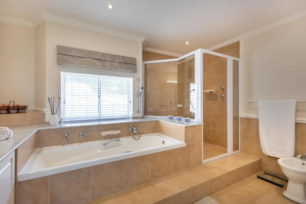 Spacious bathroom with soaking tub, separate shower enclosure, and vanity