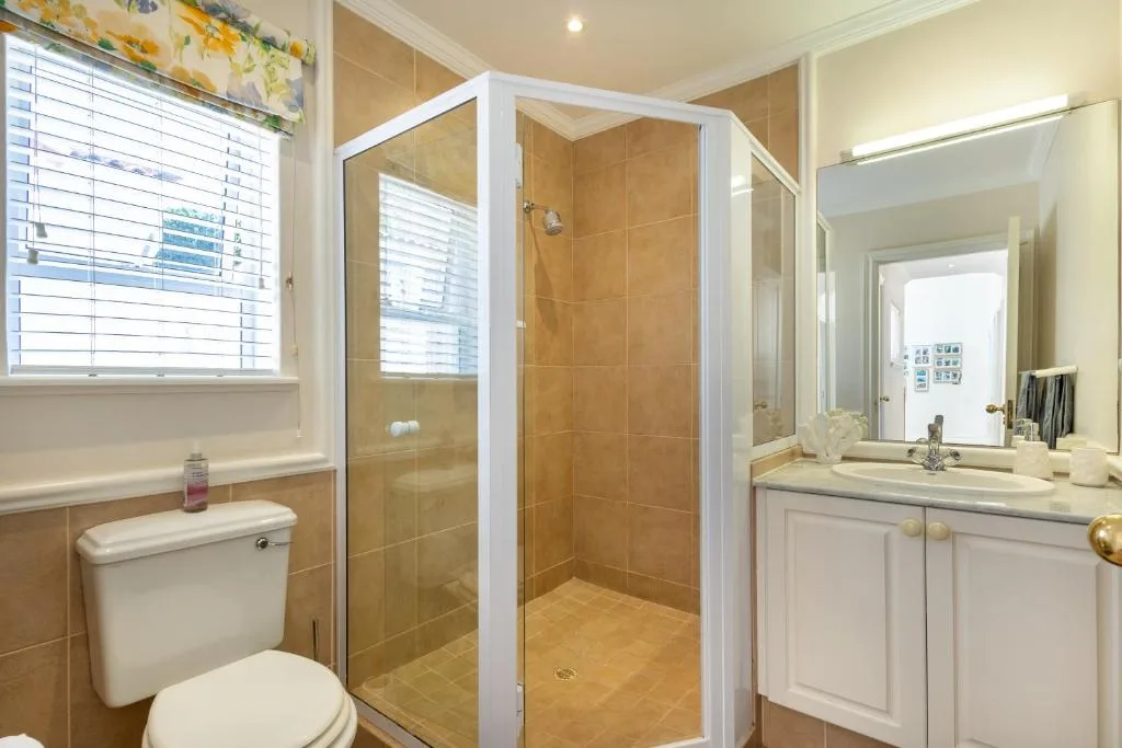 Modern bathroom with glass shower enclosure and white vanity sink