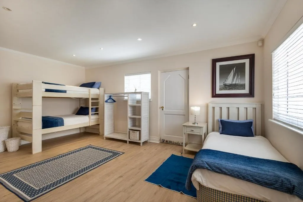 Spacious bedroom with bunk beds, single bed, and nautical décor throughout