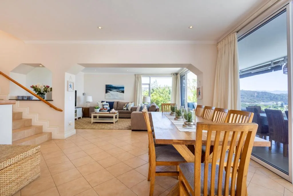 Dining area with wooden chairs and table overlooking scenic valley views