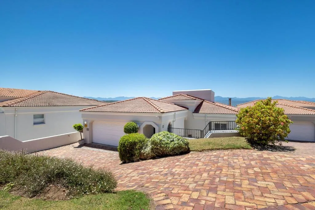 Modern white villa with terracotta roof and brick driveway in Plettenberg Bay