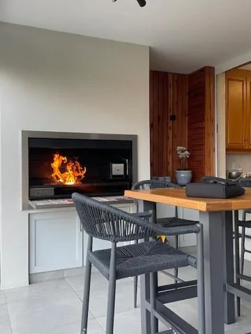 Modern fireplace with lit fire in contemporary living area with seating