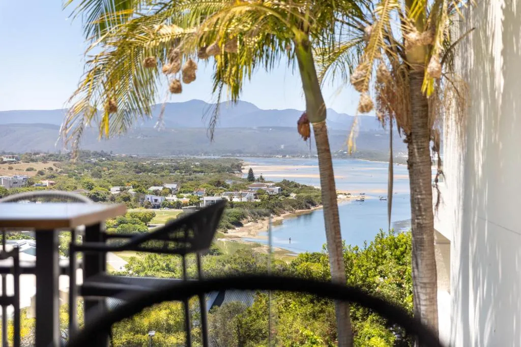Panoramic lagoon and mountain vista from elevated property deck