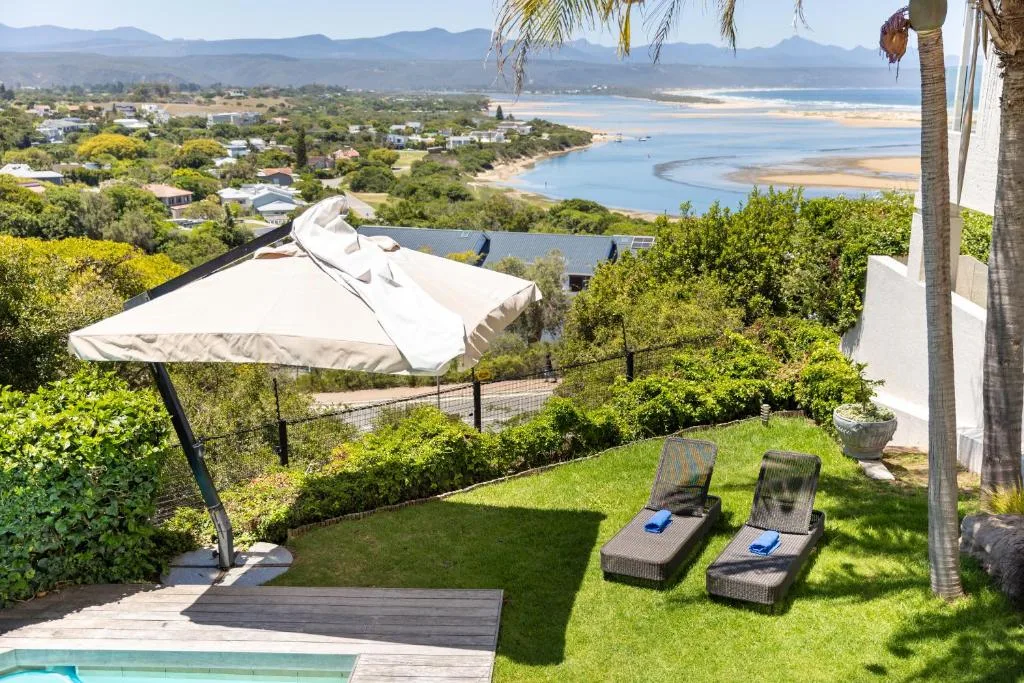 Panoramic coastal landscape with lagoon, mountains, and beachfront town sprawl