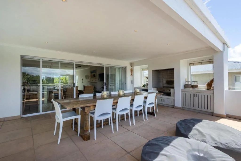 Spacious outdoor patio with dining table and modern sliding glass doors