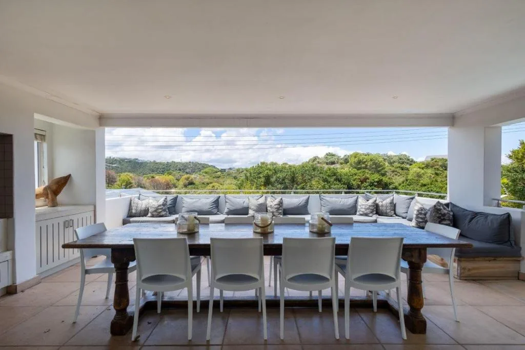 Spacious outdoor deck with dining table and mountain views