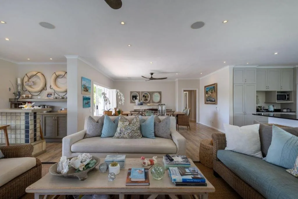 Spacious open-plan lounge with comfortable sofas and coastal décor throughout