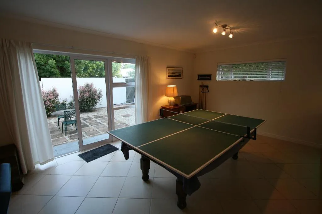 Recreation room with ping pong table and glass doors opening to patio