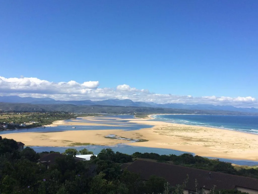 Sweeping coastal view of Plettenberg Bay with golden beaches and mountains