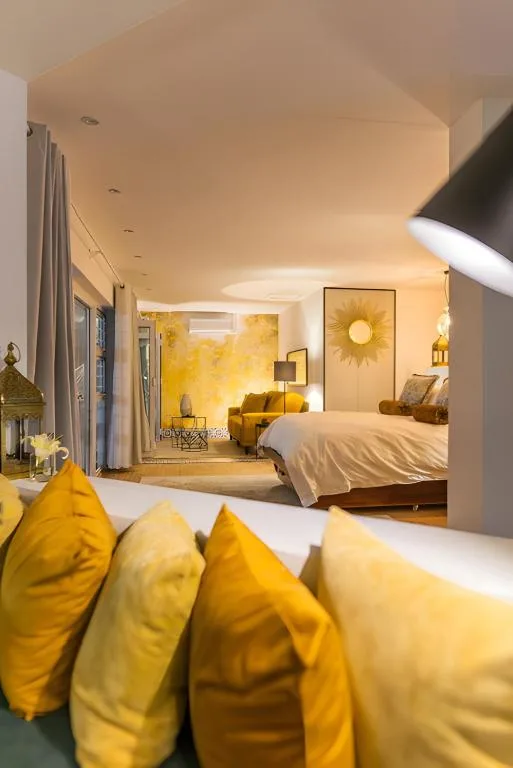 Luxurious bedroom with yellow accent pillows and modern furnishings throughout