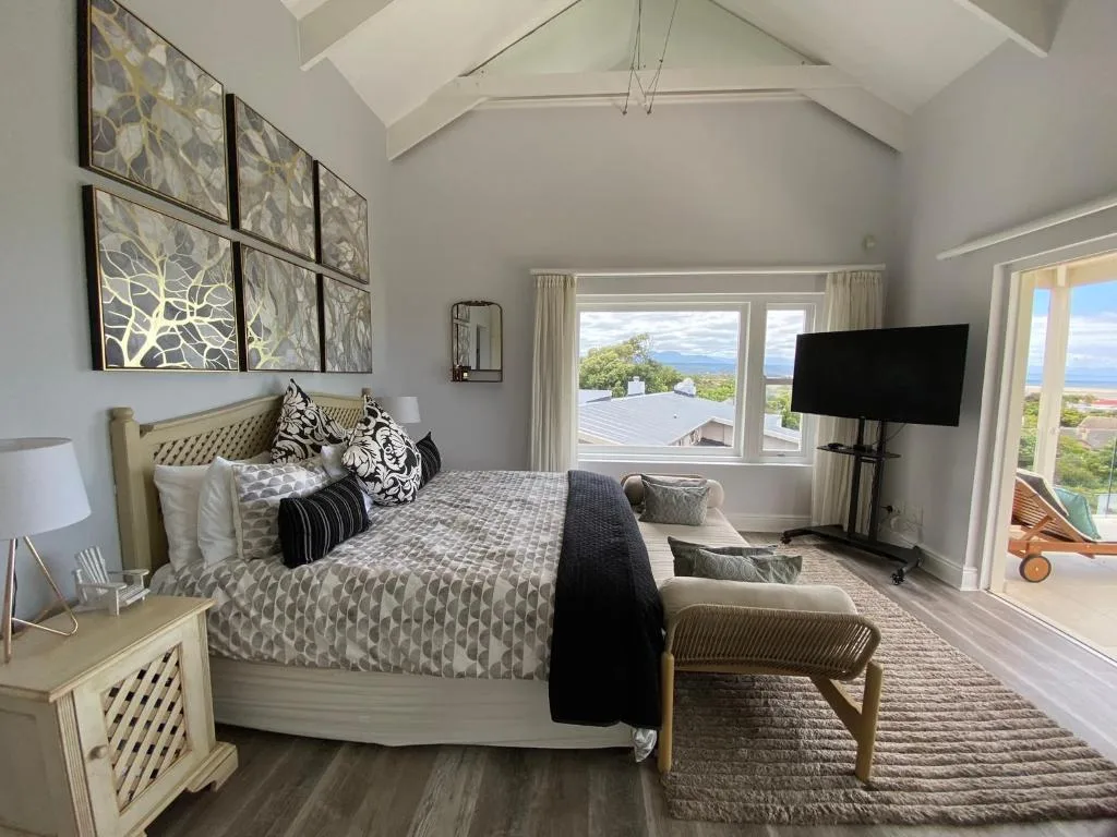 Spacious modern bedroom with ocean views through large windows