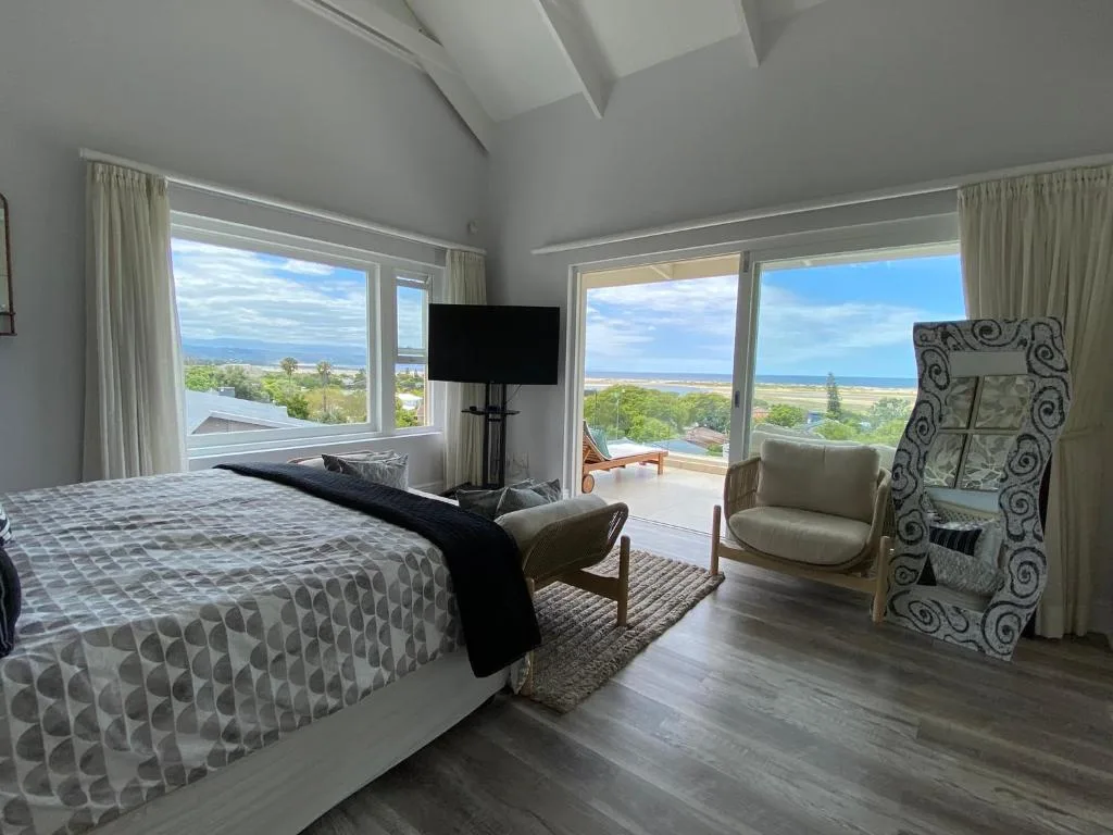 Spacious bedroom with ocean and lagoon views through large windows