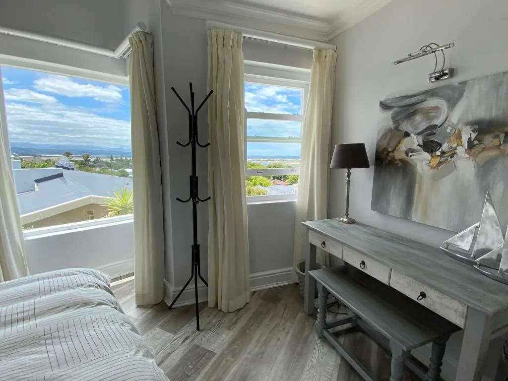Bright bedroom with ocean and lagoon views through large windows