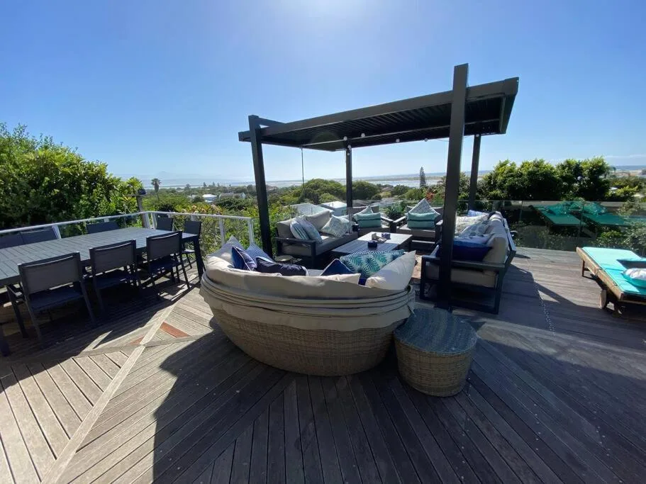 Spacious rooftop deck with lounge seating, pergola, and panoramic valley views
