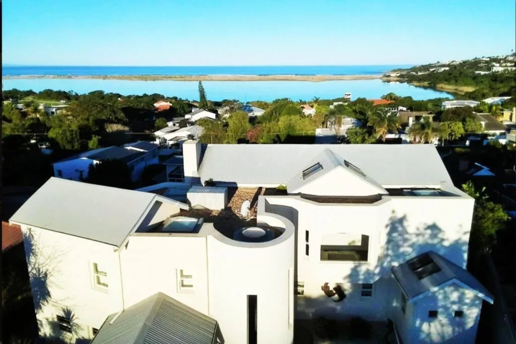 Aerial view of modern villa with lagoon and ocean beyond, Plettenberg Bay
