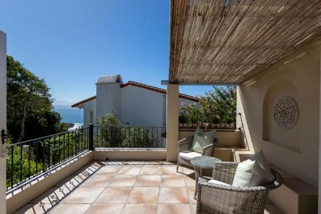 Spacious covered terrace with coastal views and comfortable seating