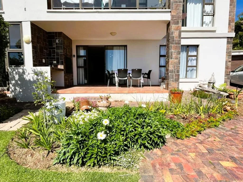 Wooden deck patio with outdoor seating and garden landscaping