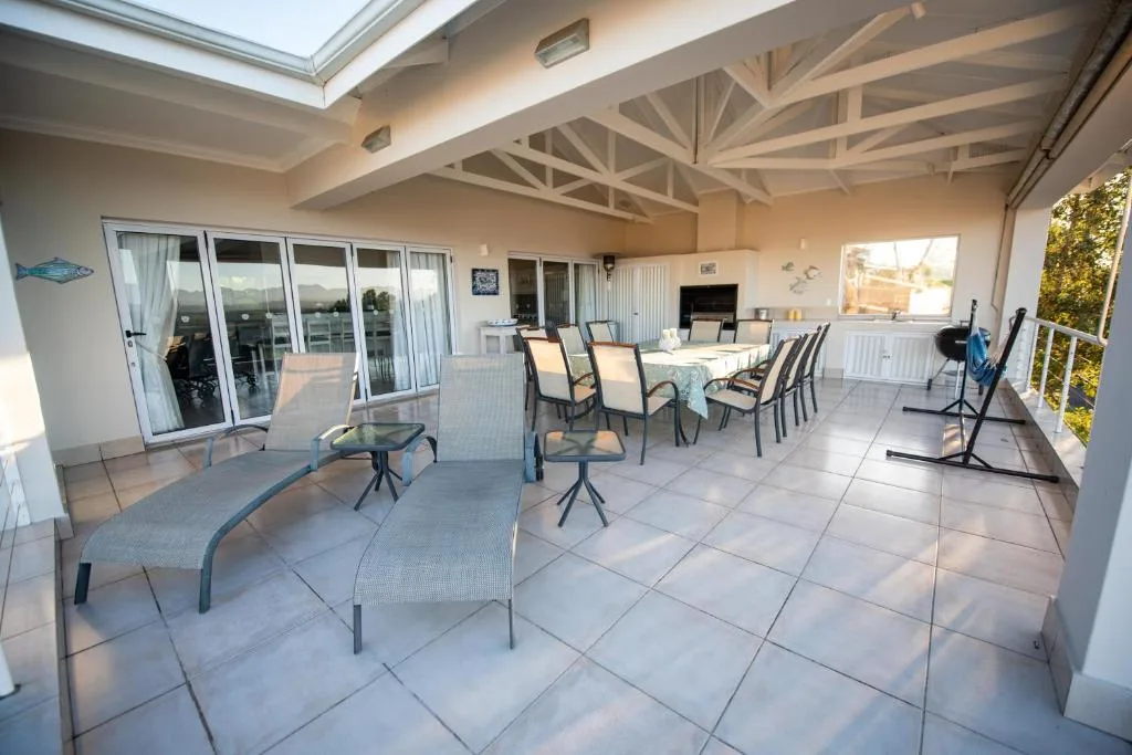 Spacious covered patio with dining table and lounge seating area