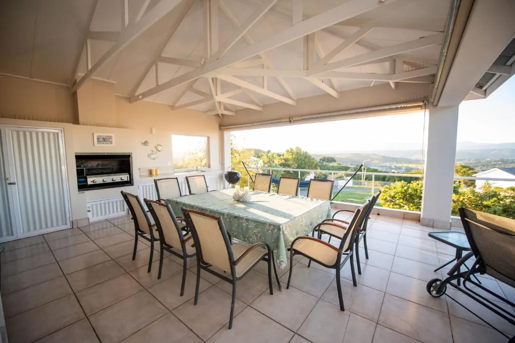 Covered outdoor dining area with scenic valley views and modern furnishings