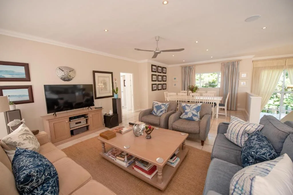 Spacious lounge with sofas, TV, coffee table and coastal decor