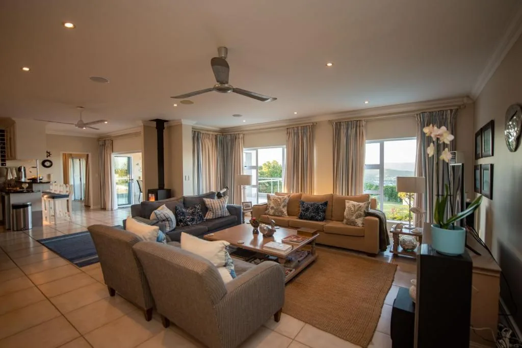 Spacious open-plan lounge with multiple seating areas and large windows